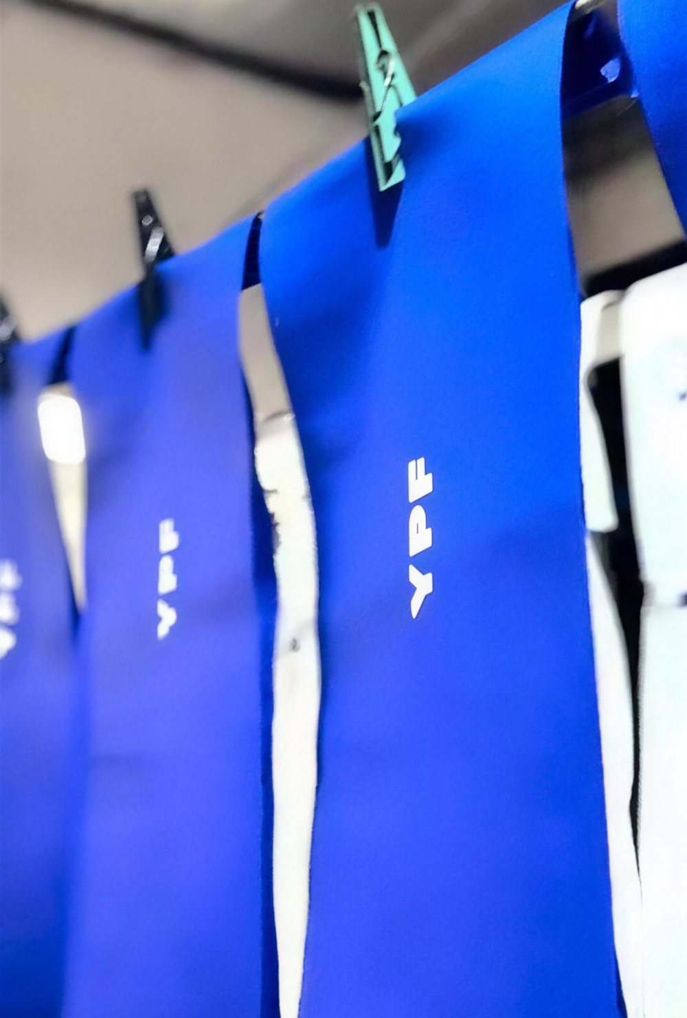 Bolsas con logo impreso colgadas para secar en el taller